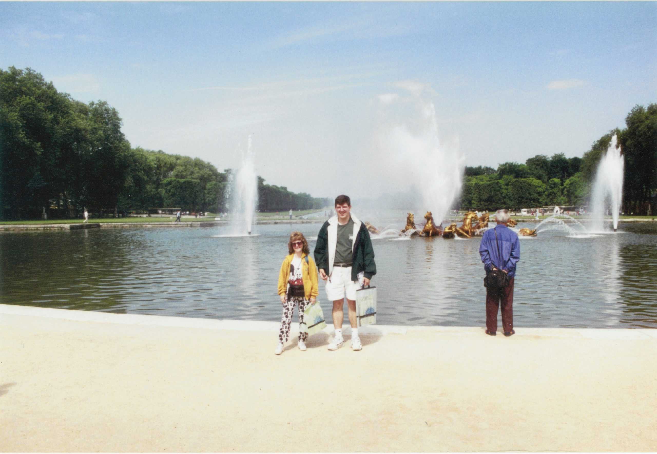 a group of people standing in front of a fountain