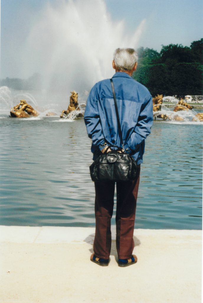 a man standing in front of a fountain