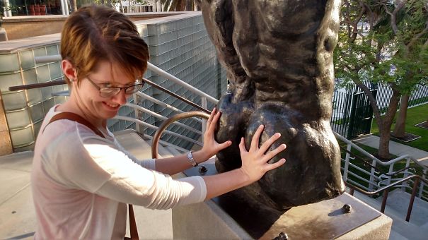 a woman touching a statue