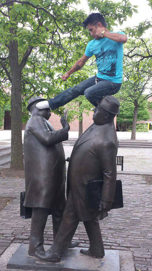 a man jumping on a statue