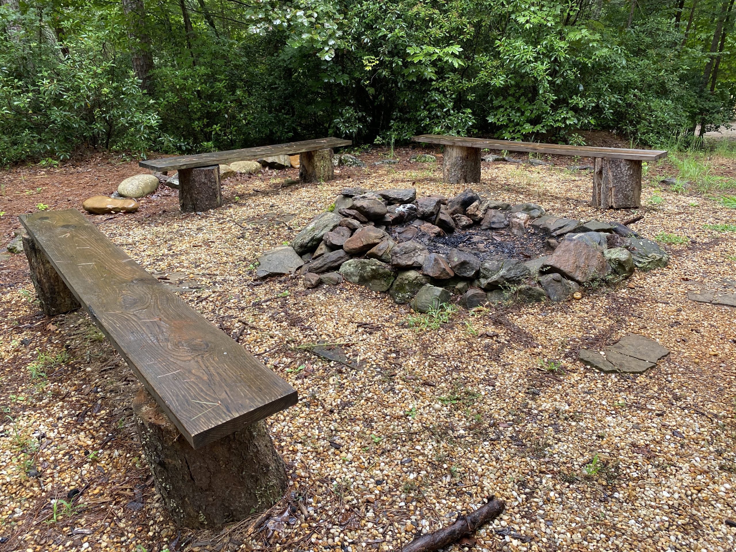 a campfire with benches around it