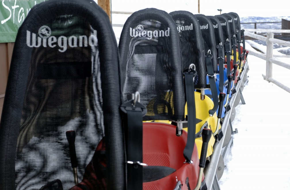 a row of sleds with seats