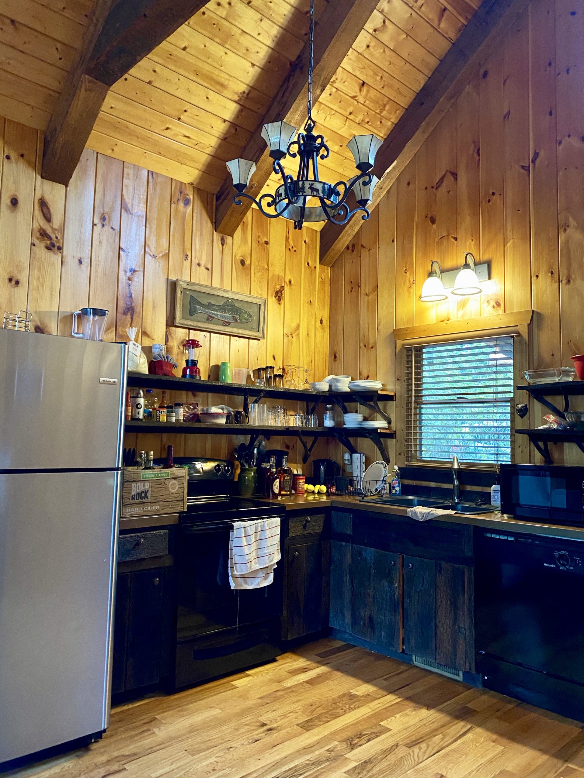 a kitchen with wood walls and ceiling