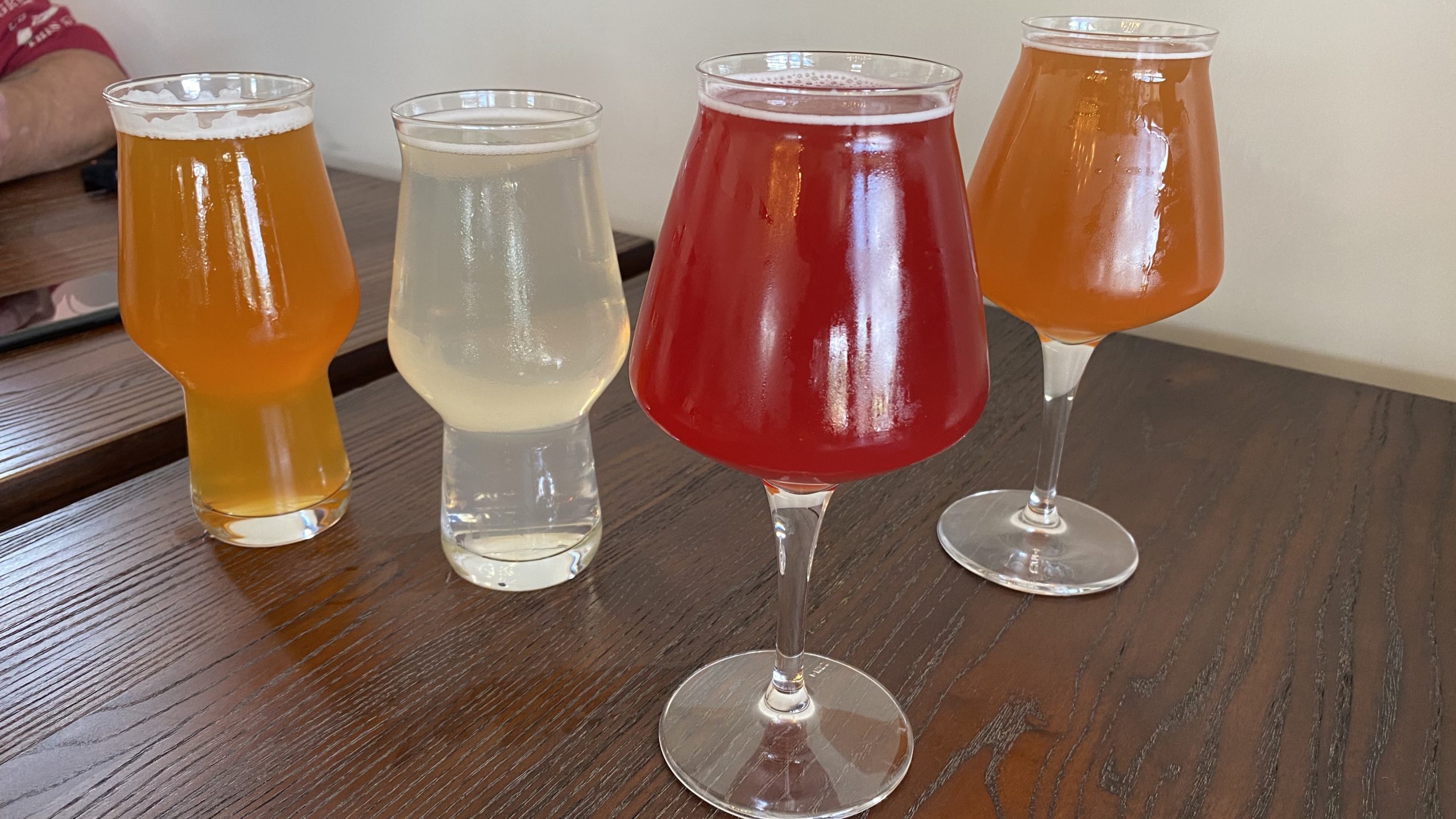 a group of glasses of different colored drinks