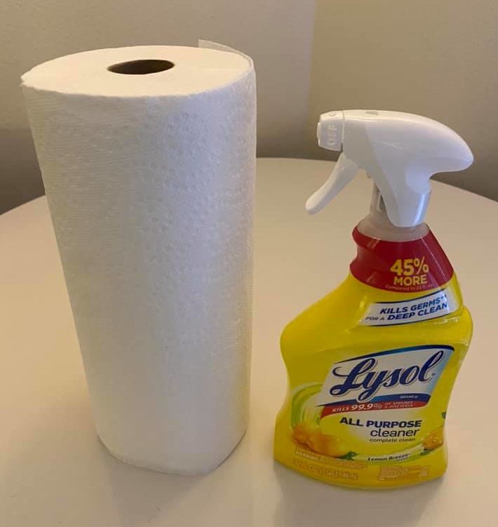 a spray bottle and a roll of paper towel