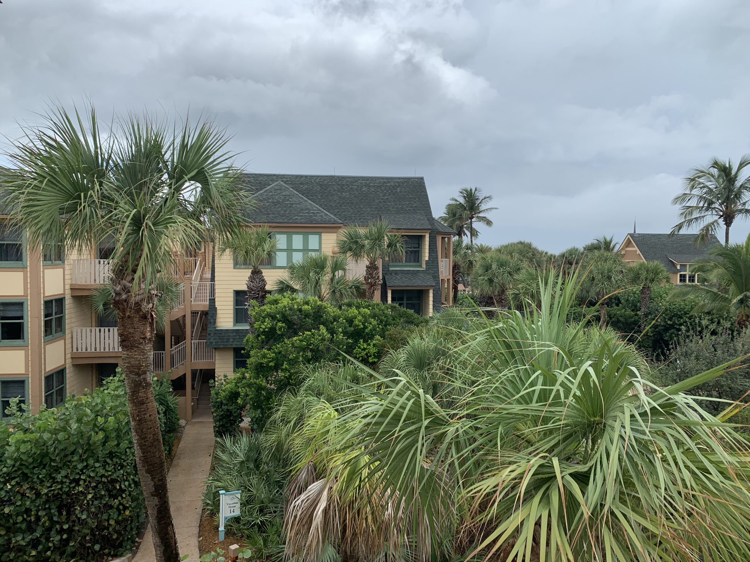 a group of houses with trees and bushes