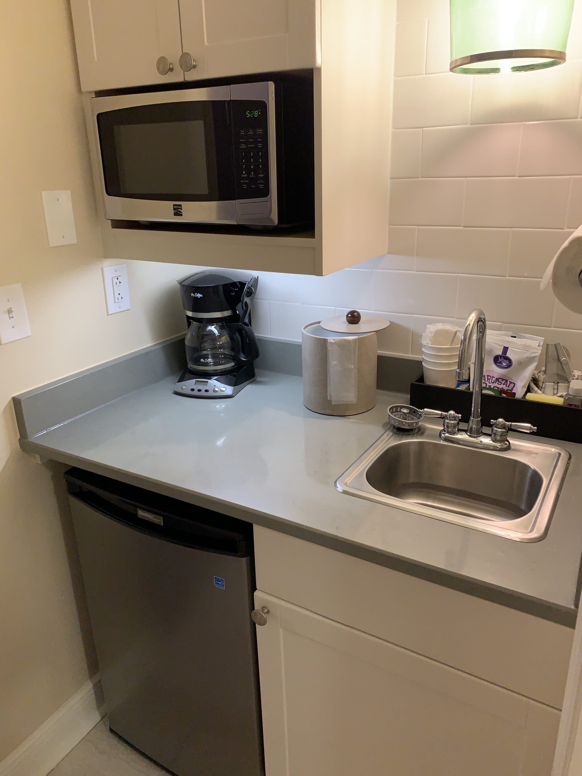 a kitchen with a microwave and a sink