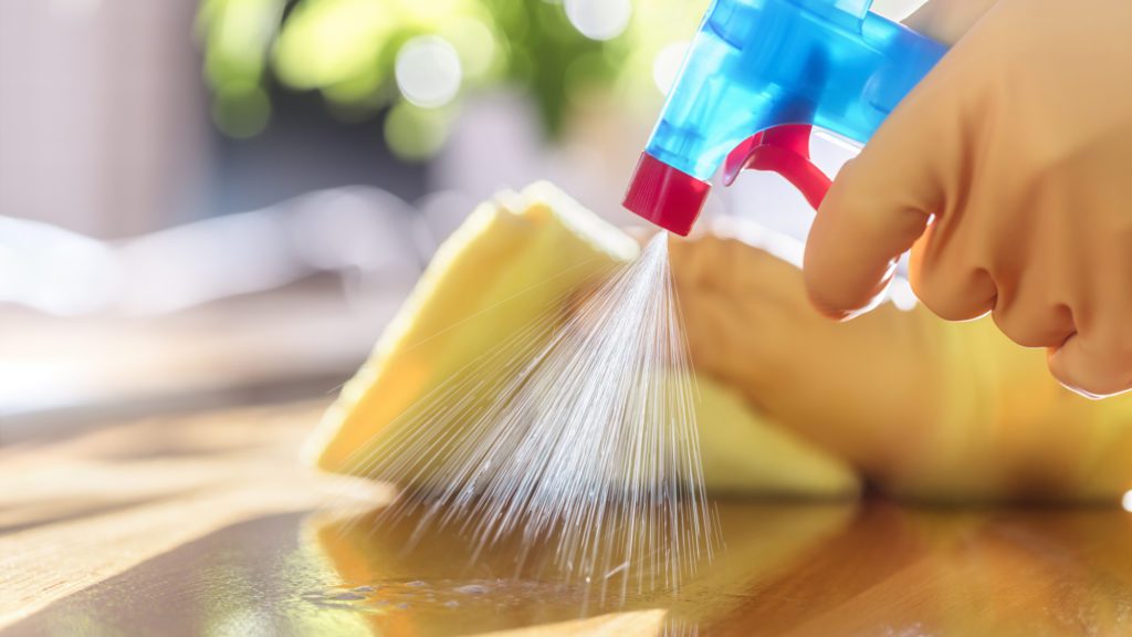 a hand spraying water from a spray bottle