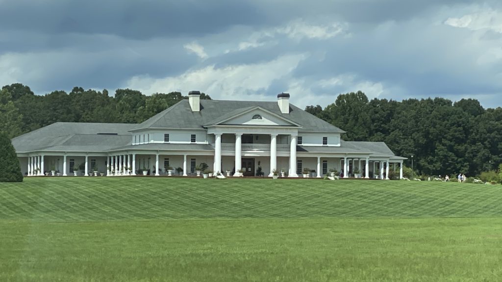 a large white house with columns and a large green lawn