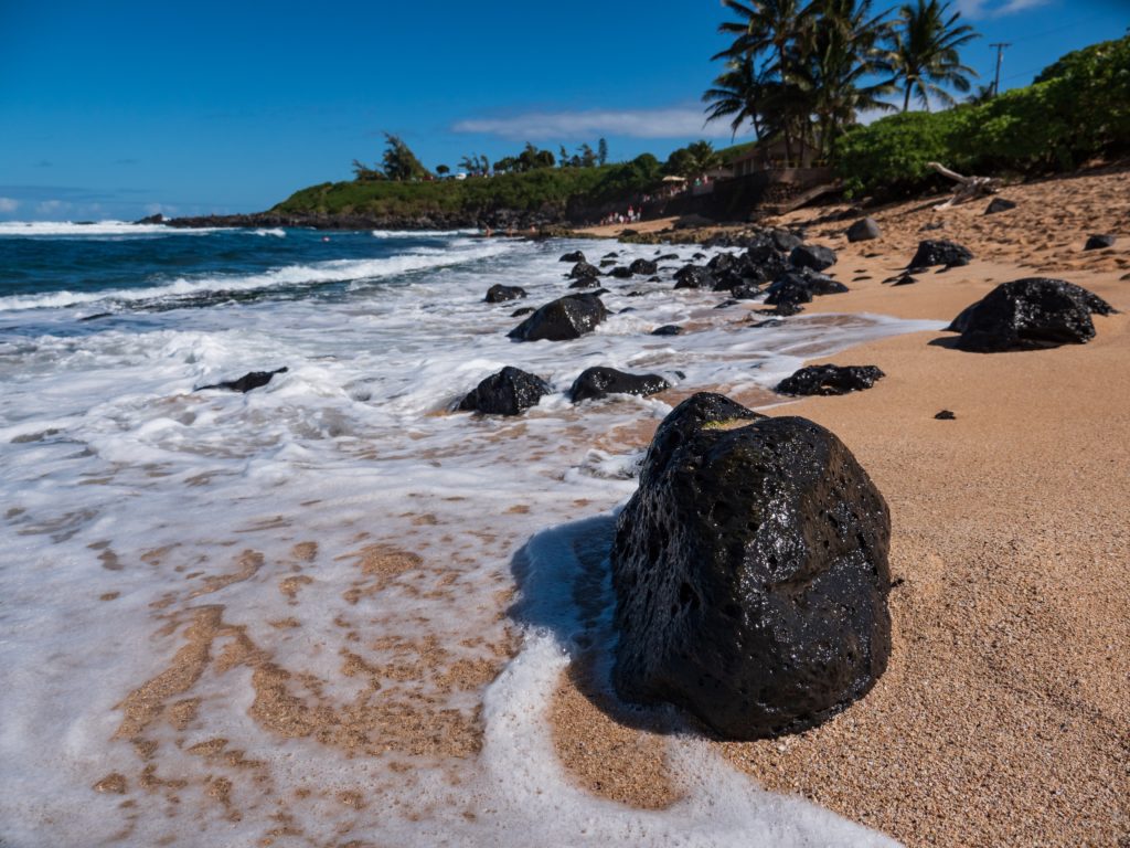 a rocky beach with waves crashing on it