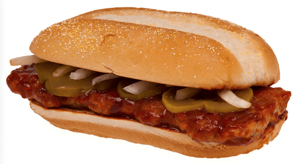 a sandwich with meat and pickles