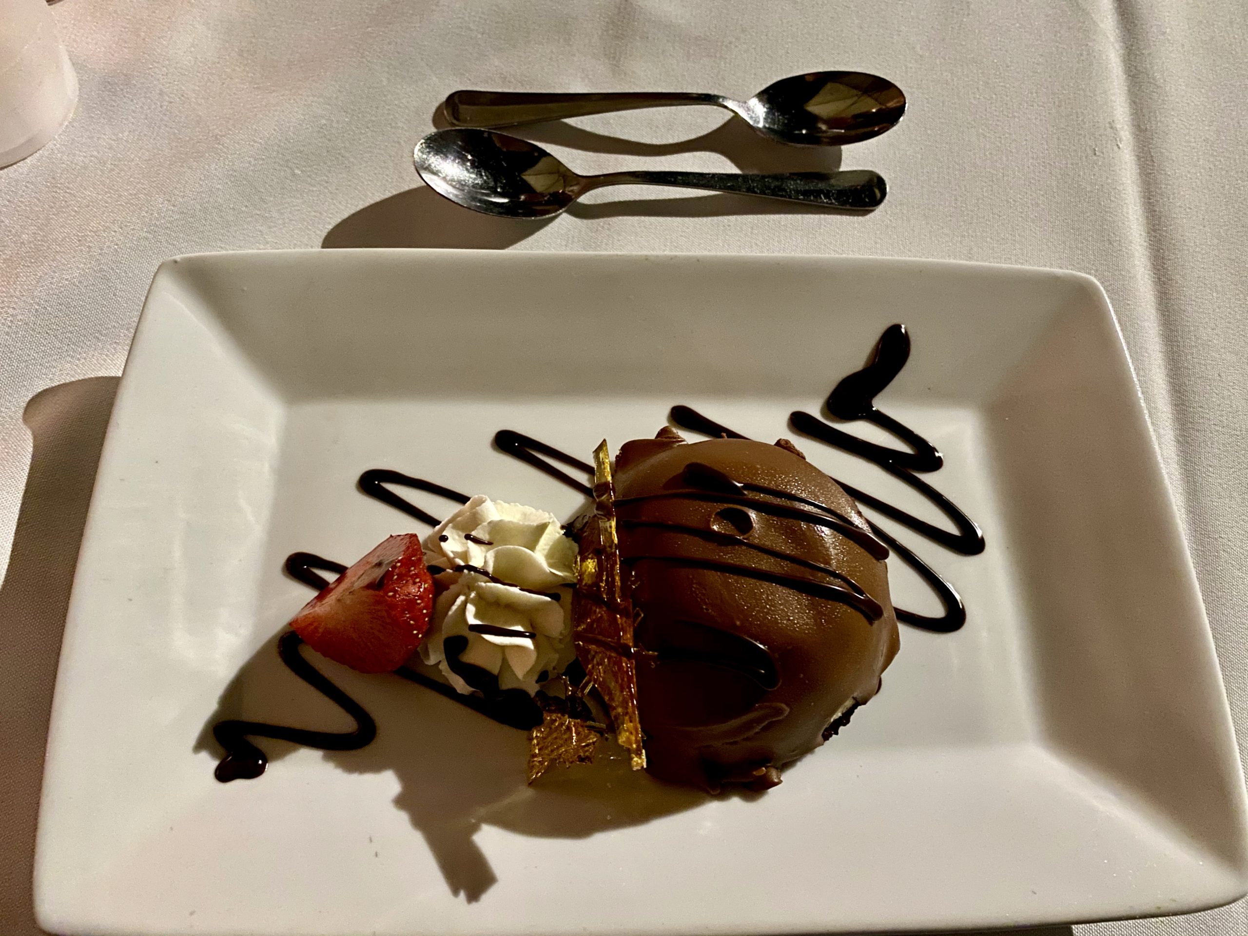 a plate of dessert with a spoon and a spoon