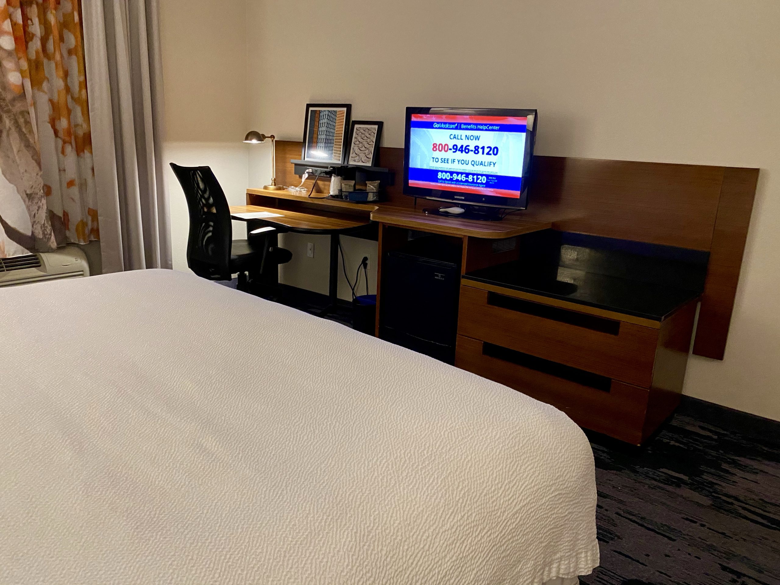 a bed with a desk and a computer