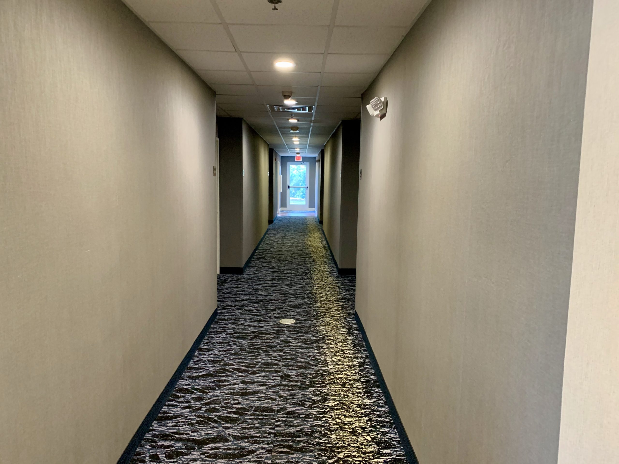 a hallway with a door open