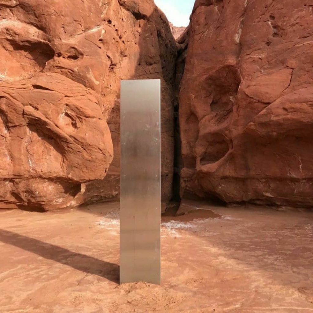 a metal pillar in a desert