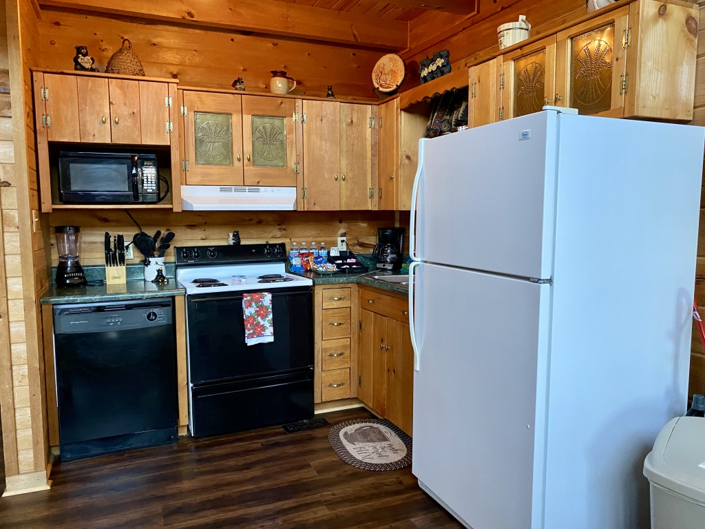 a kitchen with wooden cabinets and white refrigerator