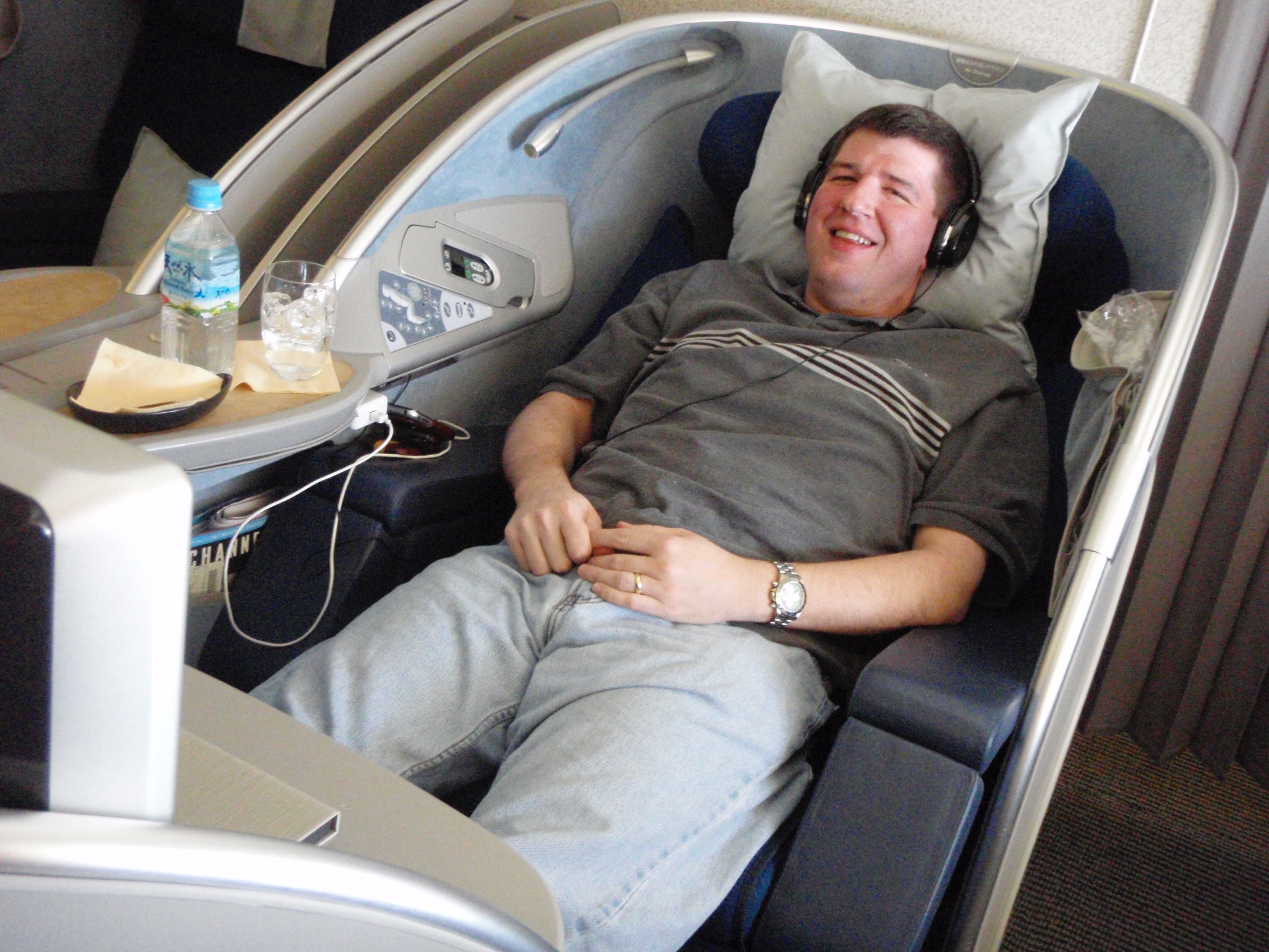 a man lying in a chair with headphones on