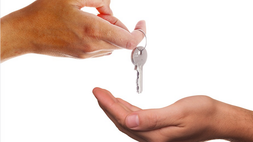 a person handing over a key