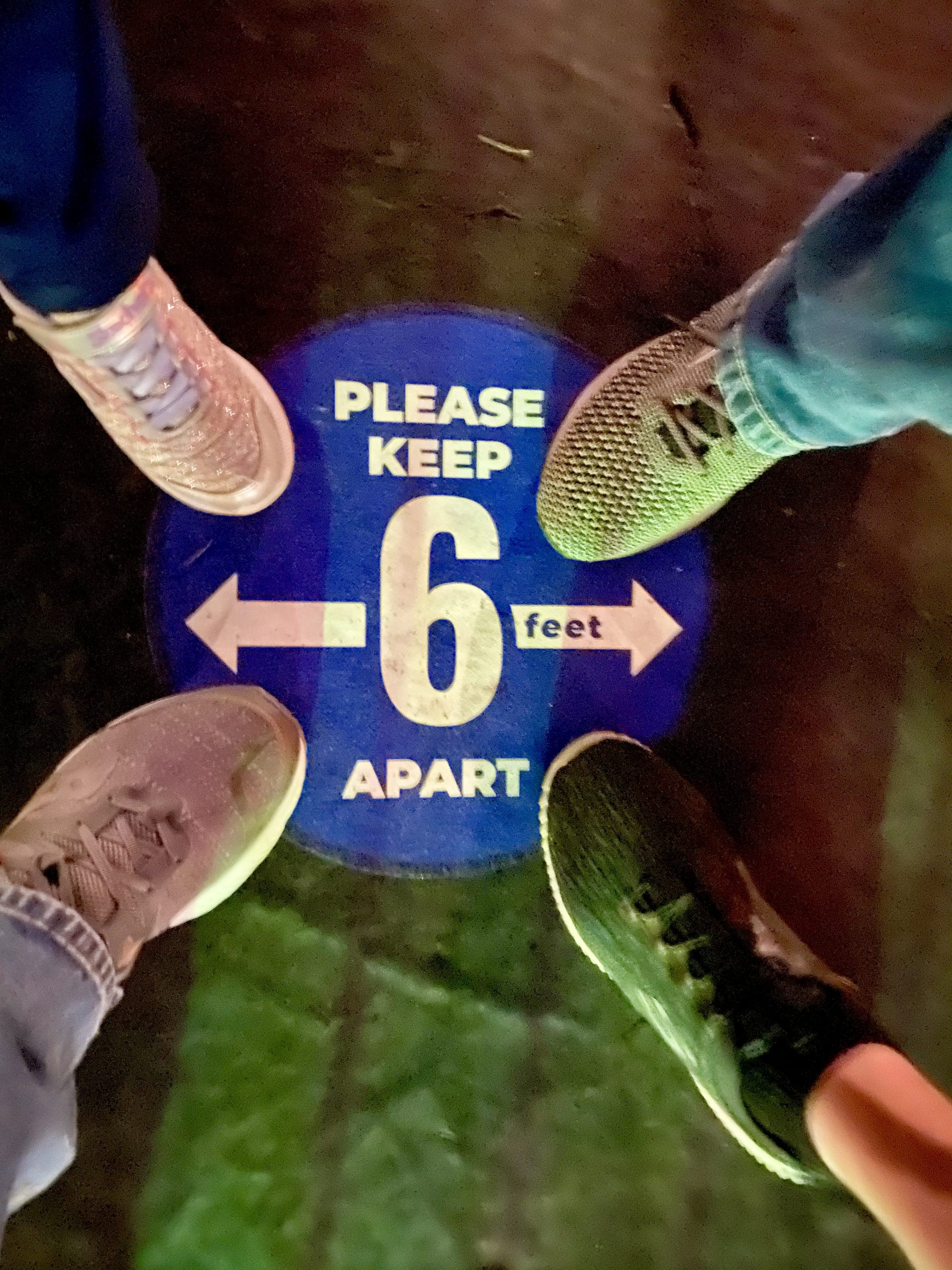a group of people standing on a blue sign