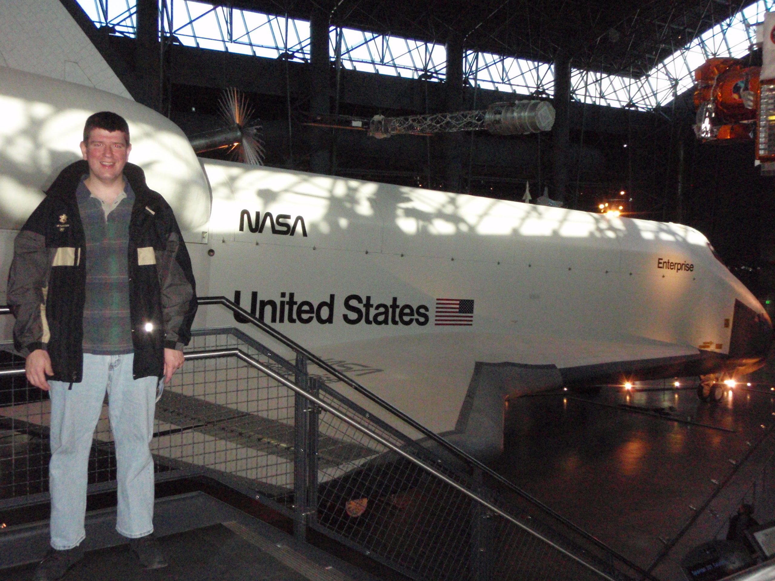 a man standing in front of a white space shuttle