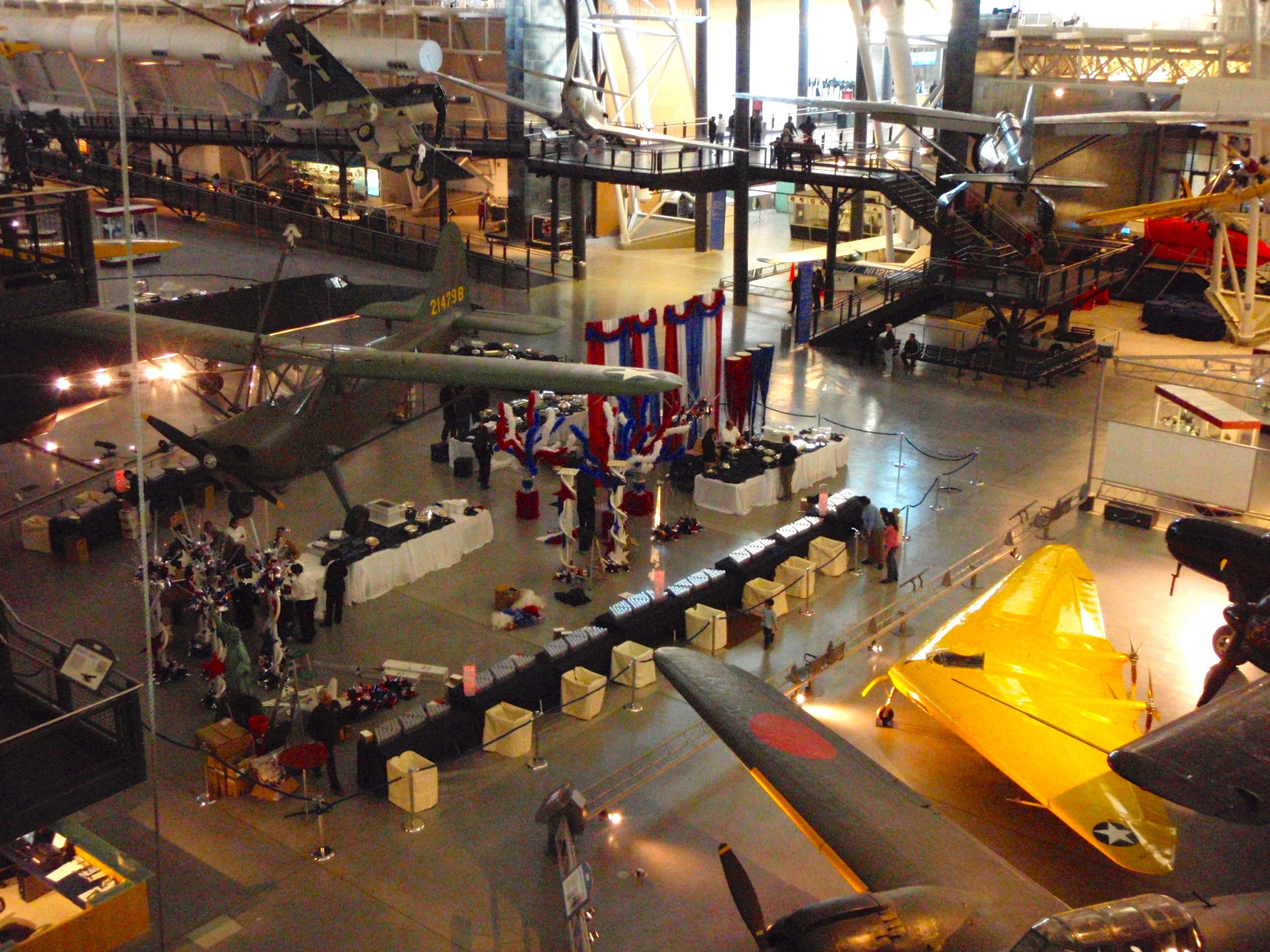 an airplane museum with people and airplanes