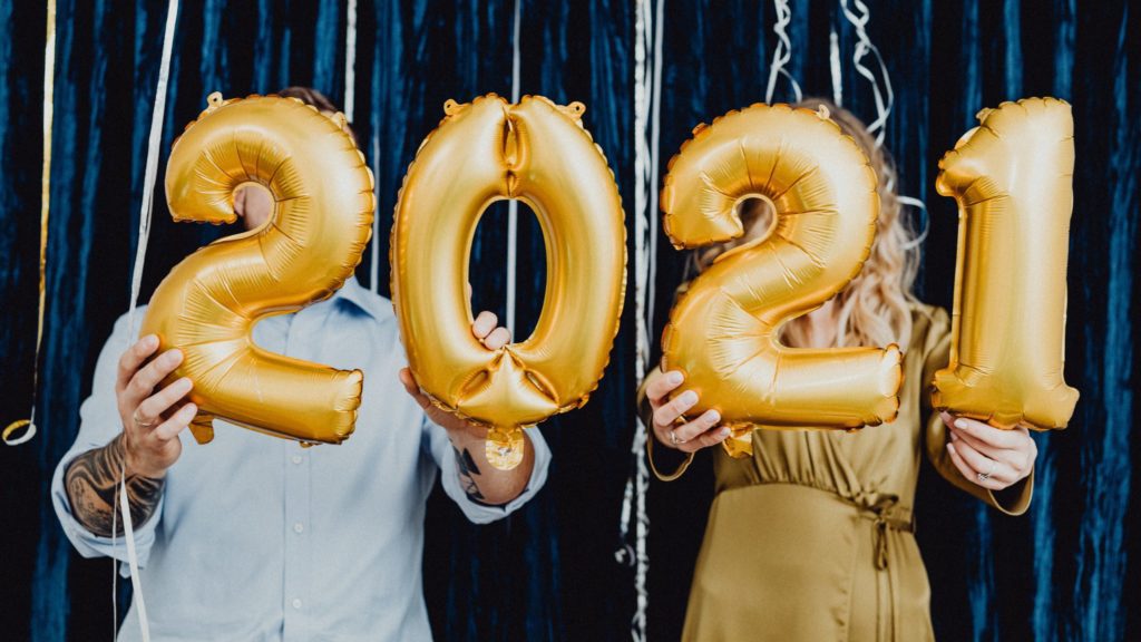 a man and woman holding balloons