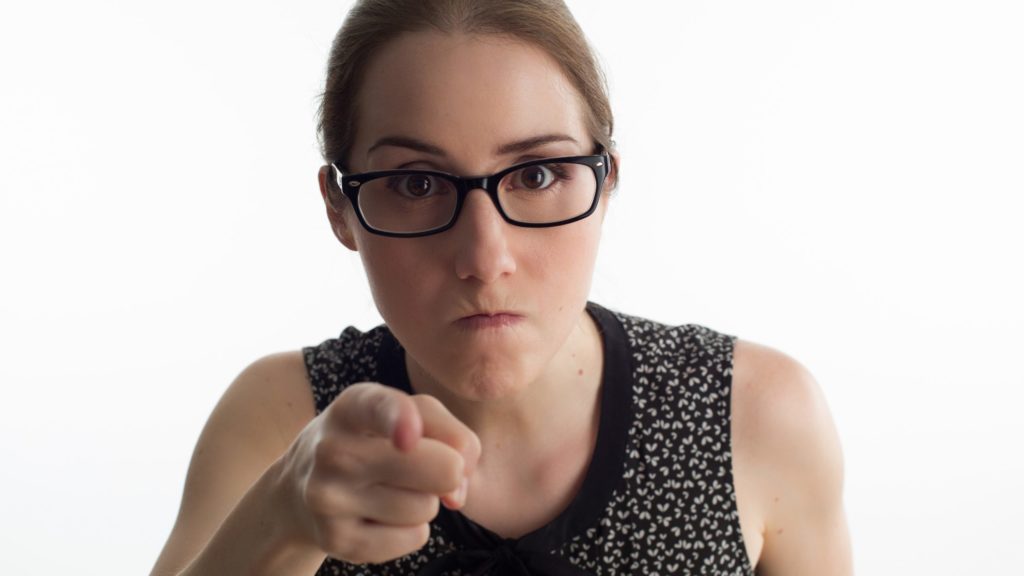 a woman pointing at camera