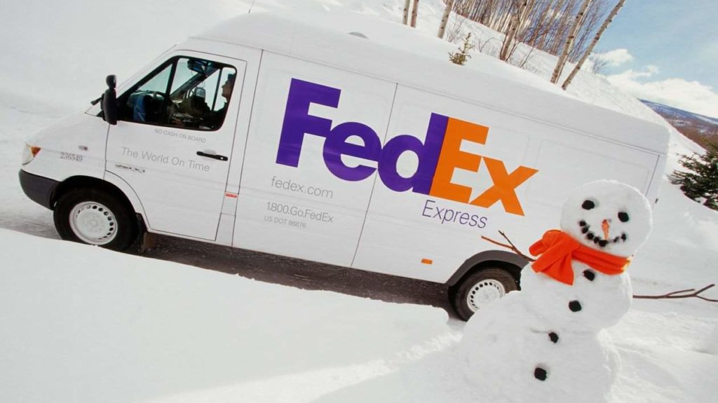 a fedex delivery van in the snow