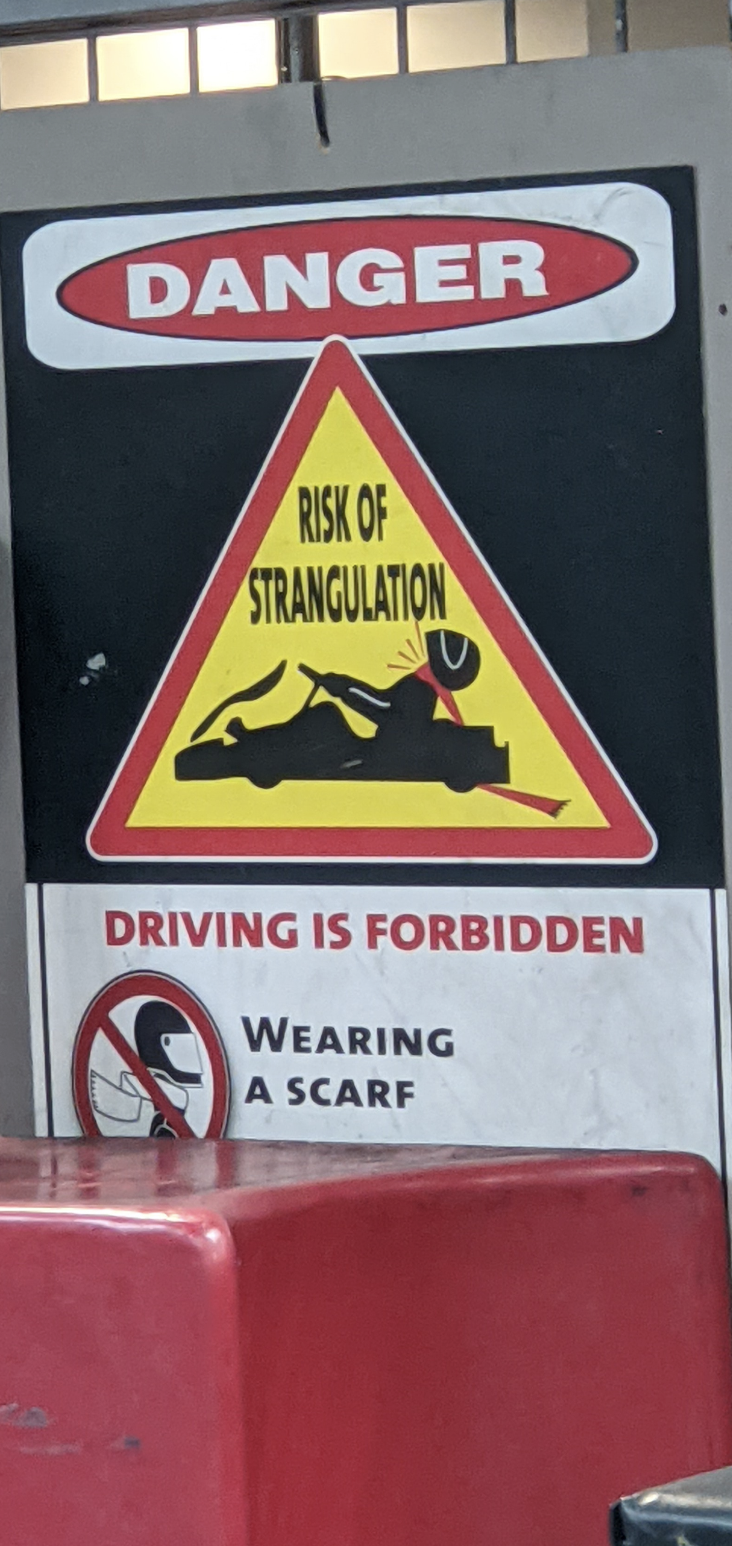a sign with a yellow triangle and black text
