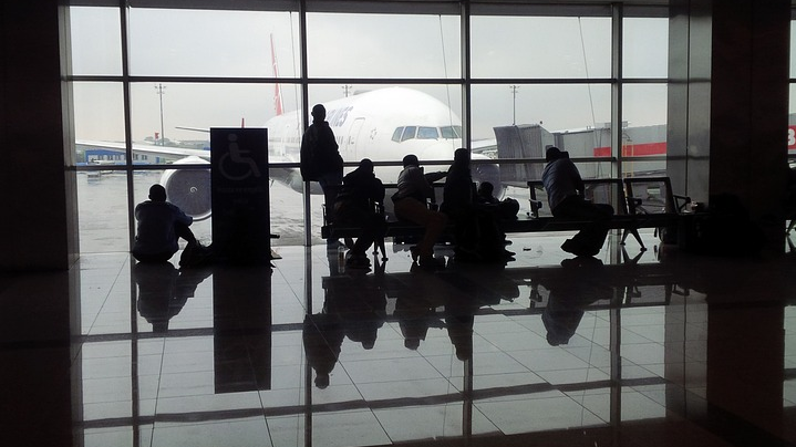 people sitting in a terminal waiting area