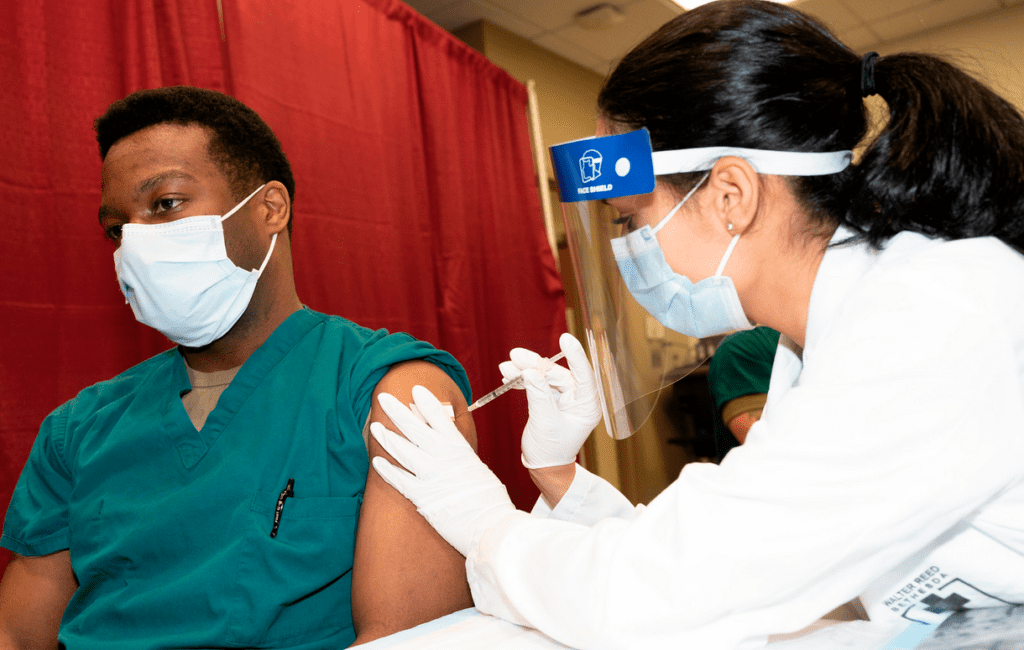 a doctor injecting a patient