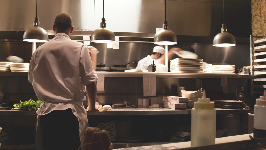 a chef preparing food in a kitchen