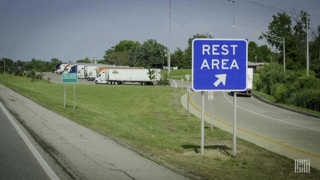 a rest area sign on a road