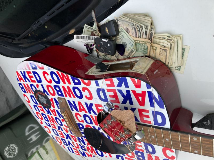 a guitar with money and keys