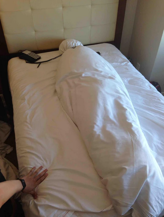 a person lying on a bed with a phone on the back