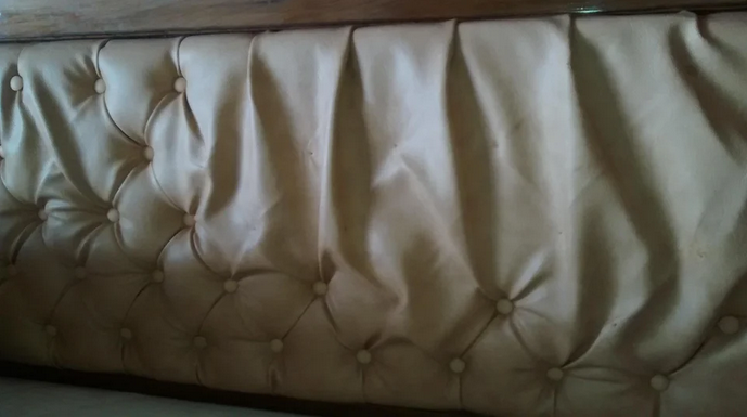 a close up of a leather headboard