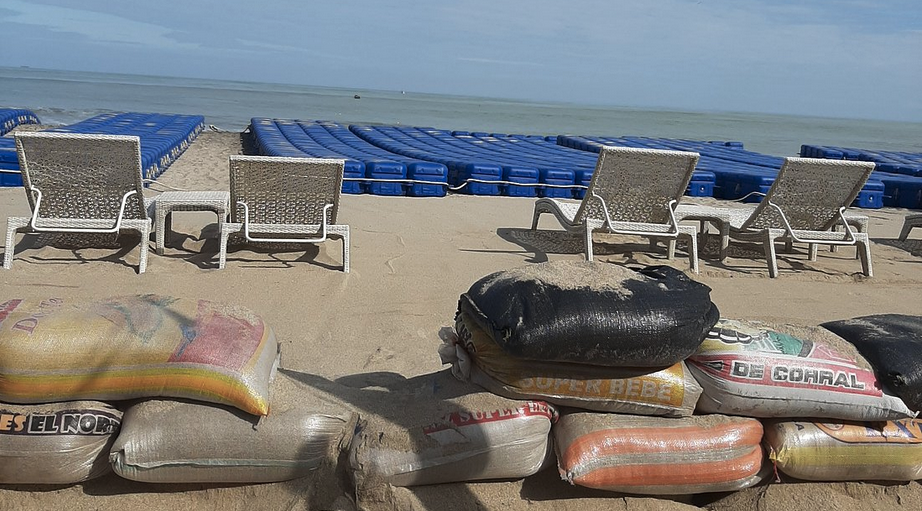 a beach chairs and sandbags on a beach
