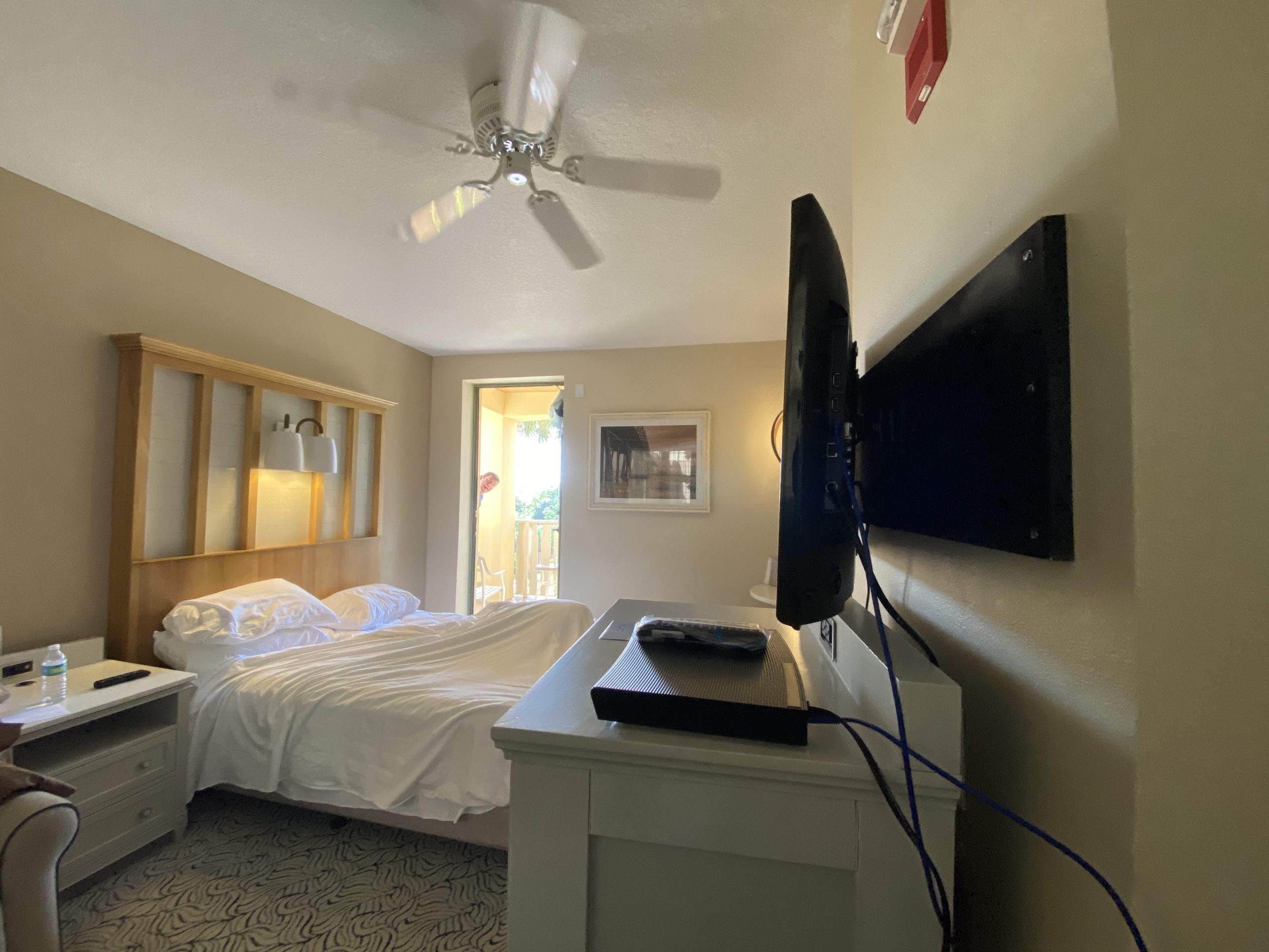 a tv on a wall in a bedroom