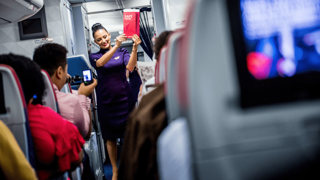 a woman holding a red sign in a plane