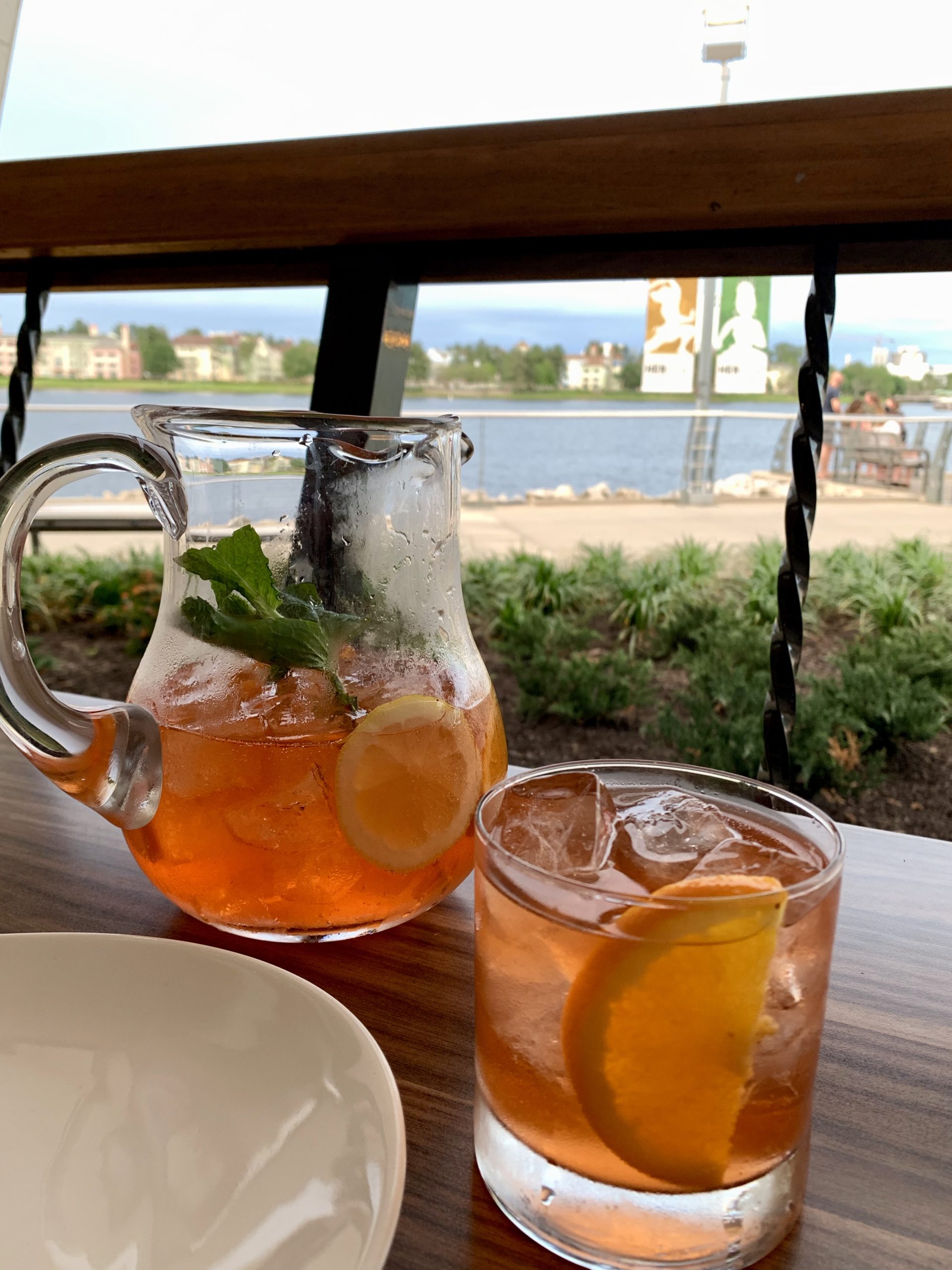a pitcher of ice tea and a glass of ice on a table