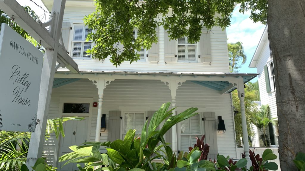 a white house with a tree in front