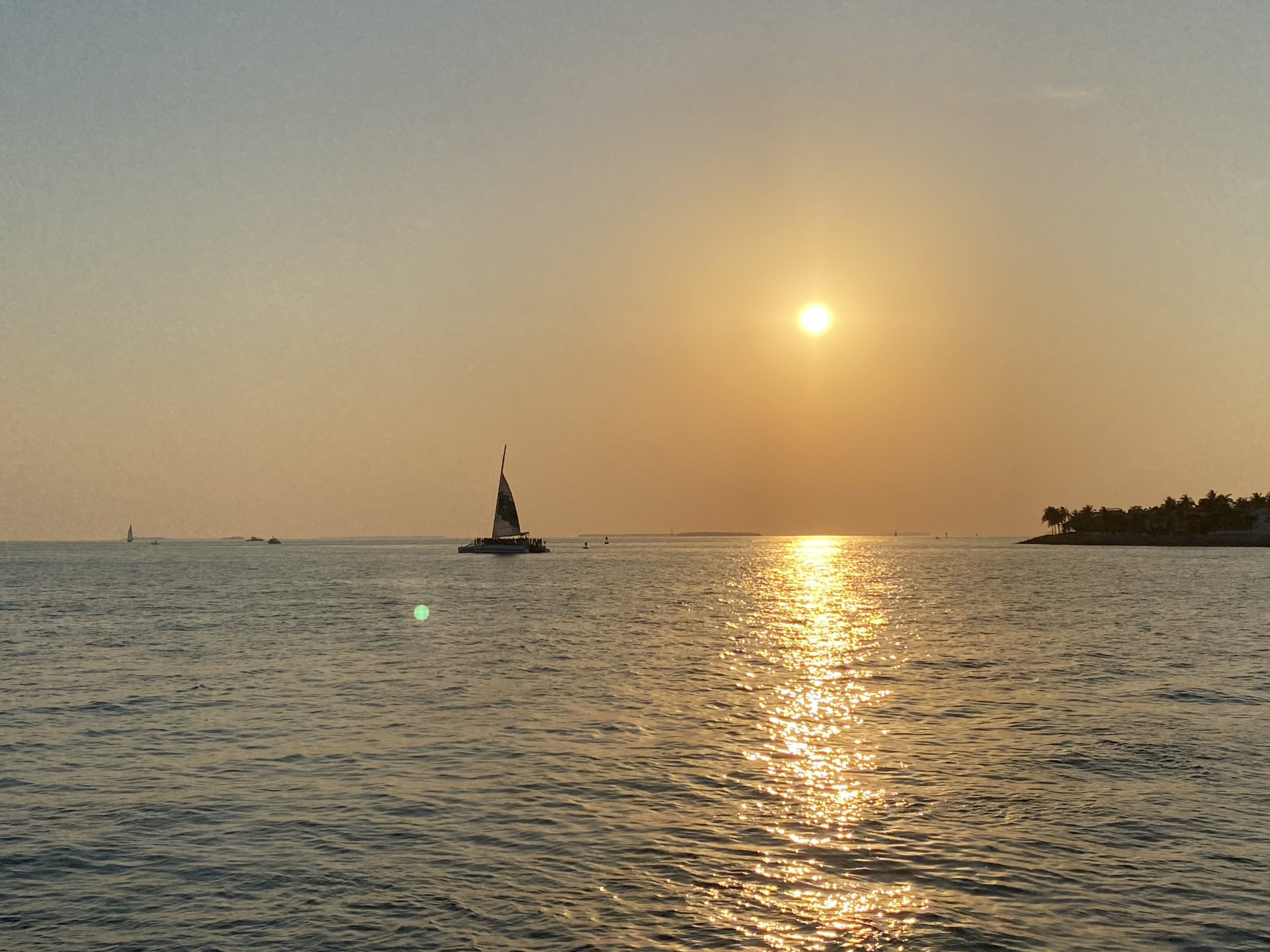 a body of water with a lighthouse in the distance