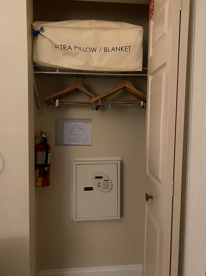 a closet with a white box and swingers