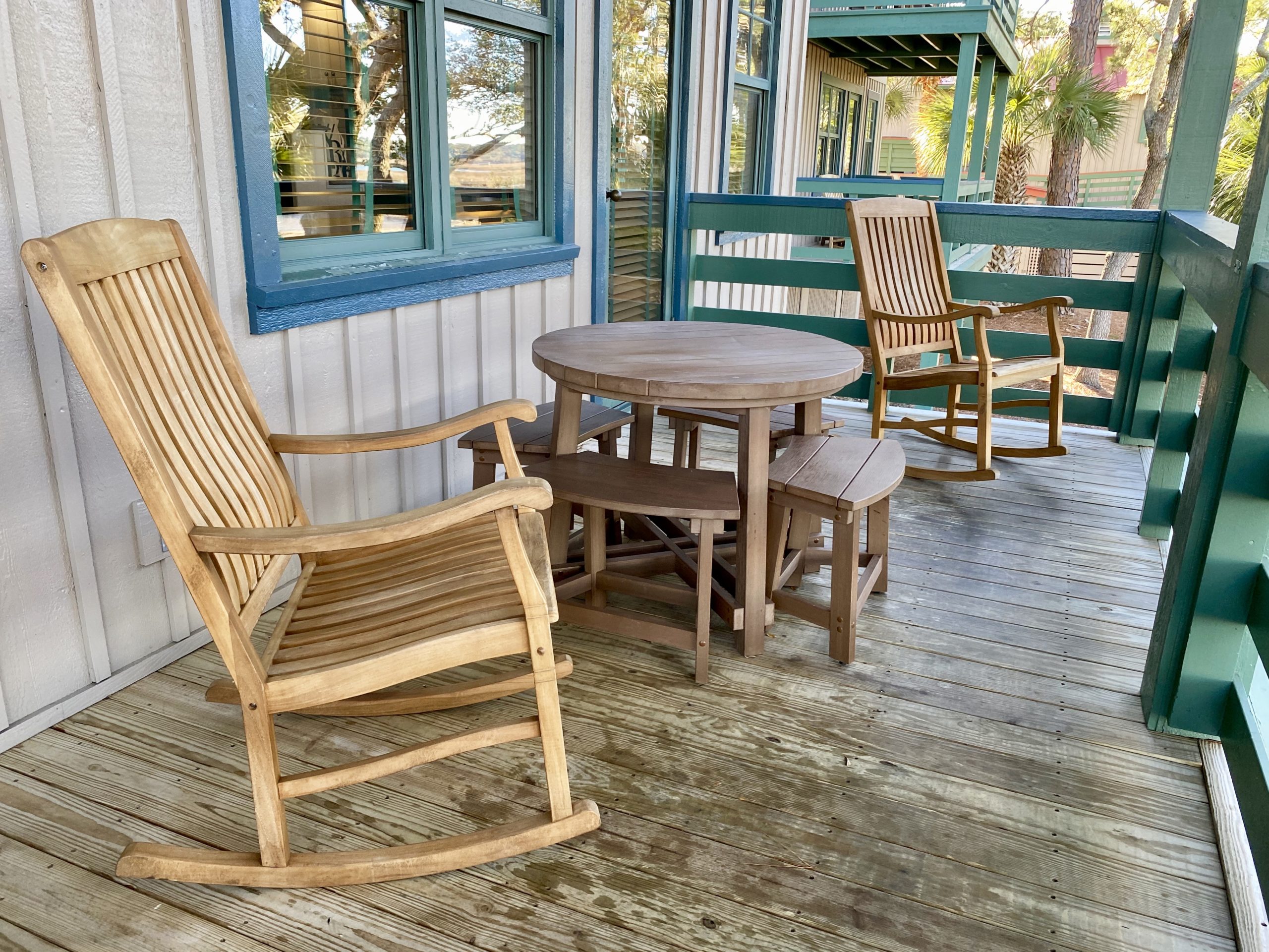 a wooden chairs and a table on a porch