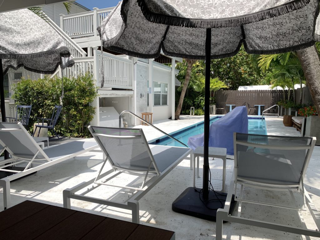 a patio with a pool and chairs