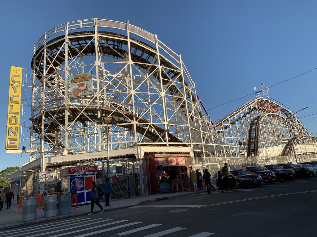 a roller coaster with people walking around