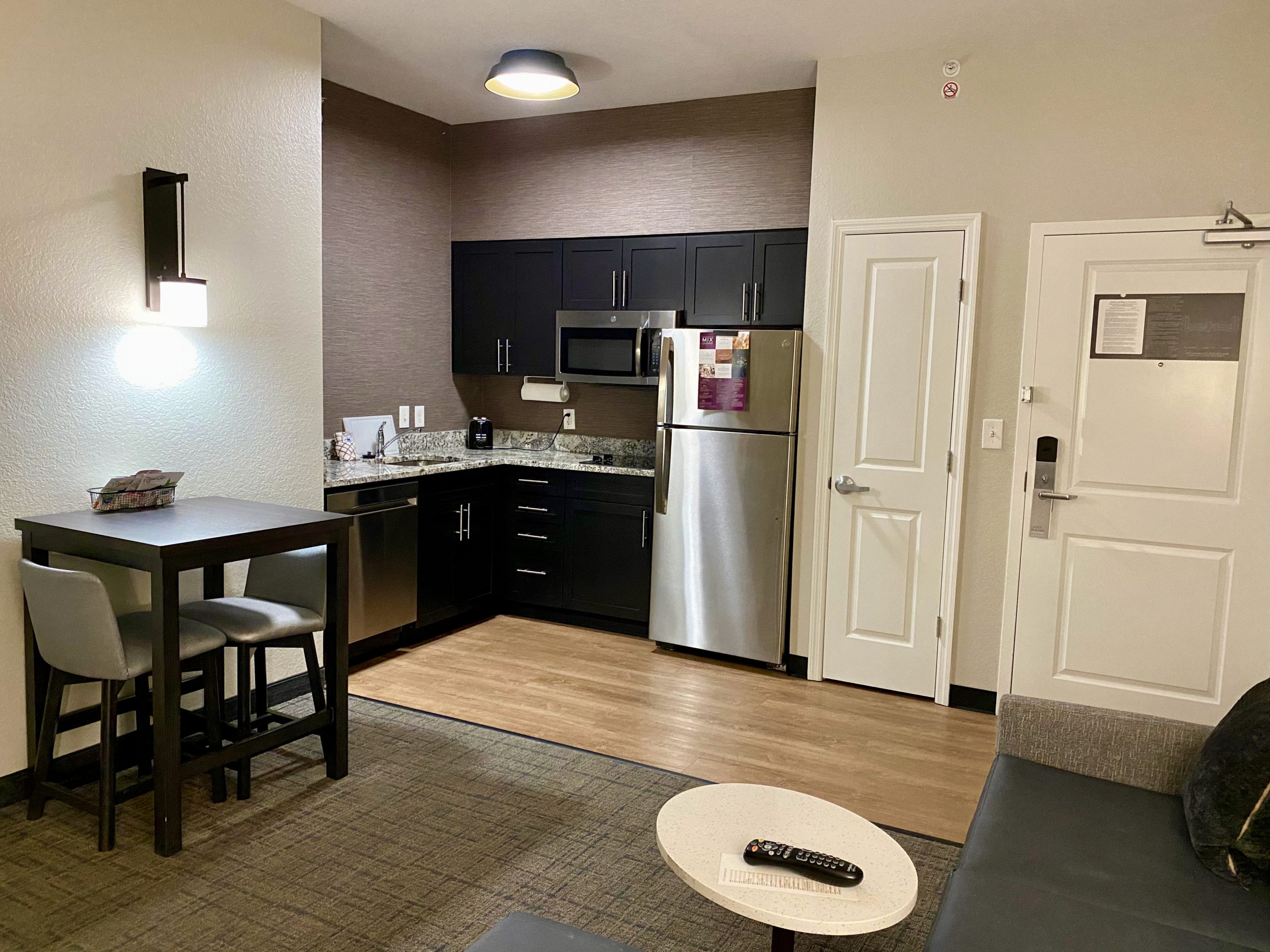 a kitchen and dining area in a hotel room