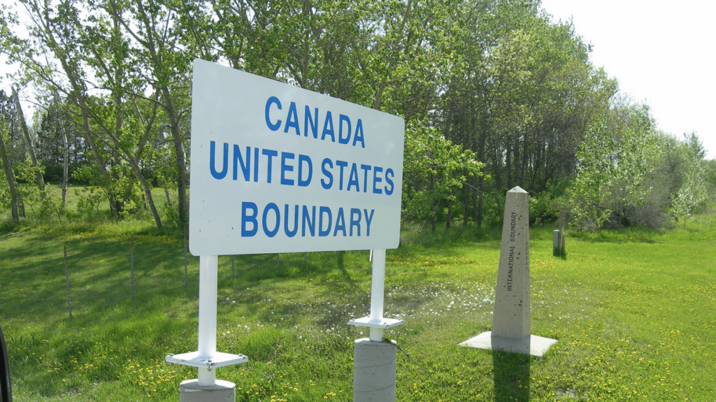 a sign in a grassy field