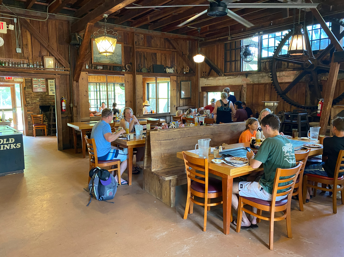 a group of people sitting at tables in a restaurant