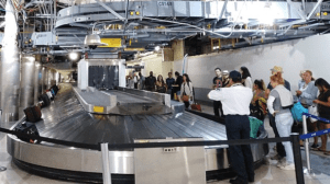 a group of people standing around a conveyor belt